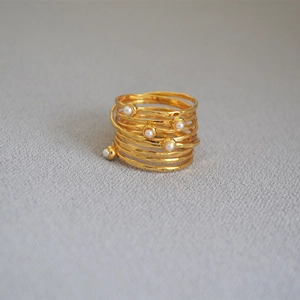 Detailed view of handmade multi-layer gold wire wrap ring with pearls and hammered texture
