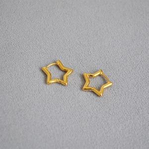 Polished gold plated brass star hoop earrings on a textured minimalist background