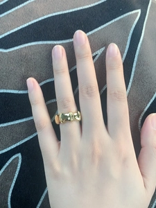 Macro detail of chunky gold bamboo-style ring with a polished molten metal texture