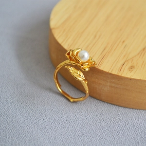 Vintage gold rose ring with pearl center and leaf texture on adjustable band