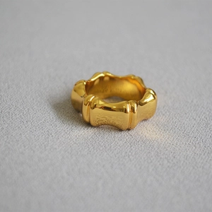 Polished gold bamboo textured ring for women with organic minimalist design features