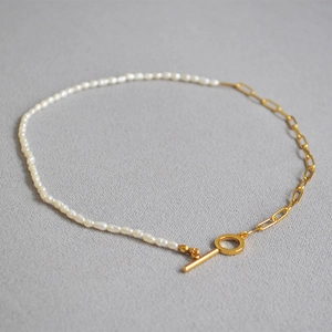 Detail of freshwater pearl necklace with gold paperclip chain and toggle clasp closure