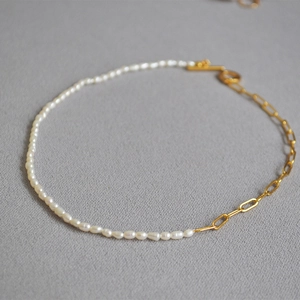 Elegant gold link chain and freshwater seed pearl necklace with a toggle clasp closure
