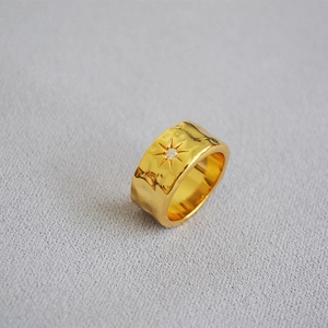 Hammered texture gold plated brass ring featuring a north star zircon centerpiece