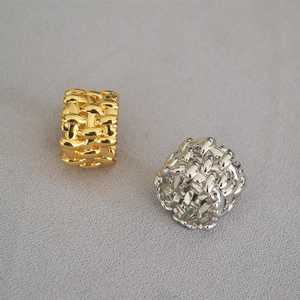 Macro detail of gold and silver woven texture on irregular mesh wide band rings