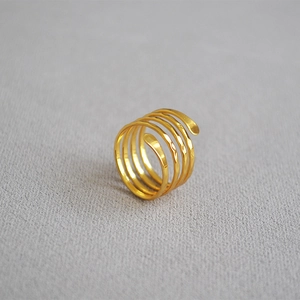 Macro detail of multi-layered gold hammered ring with vintage spiral wrap design