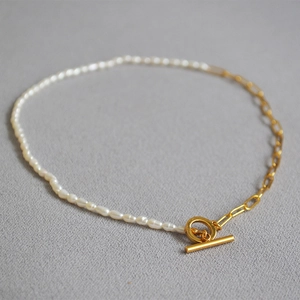 Elegant gold paperclip chain and white pearl necklace featuring a classic OT toggle clasp