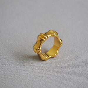 Detailed view of wide gold-plated bamboo joint ring with a high-polished mirror finish