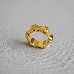 Macro shot of polished 18K gold plated bamboo joint ring with glossy mirror finish surface
