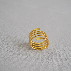 Detail view of gold multi-layer spiral ring with handcrafted hammered texture finish