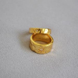 Detail of gold-plated brass ring with hammered texture and North Star zircon inlay