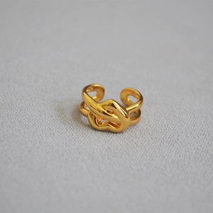 Detailed view of gold-plated brass knot ring with an abstract heart-shaped design