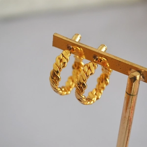 Golden twisted rope hoop earrings with braided texture and high-polish metallic finish