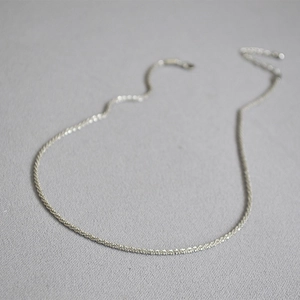 Macro shot of silver sparkling textured chain choker necklace with lobster clasp