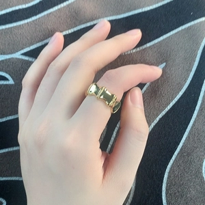 Polished gold-plated brass wide bamboo link ring worn on index finger for women