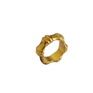 Polished gold plated bamboo style wide ring with an organic flowing wave design for women
