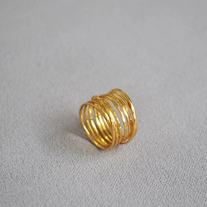 Macro shot of gold multi-layer wrap ring featuring artisanal hammered texture and pearls