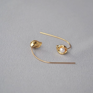 Minimalist gold shell pearl earrings with delicate floral bud design and hook closure