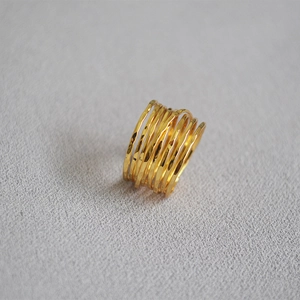 Detail view of handmade gold multi-layer wrap ring with artisan hammered texture