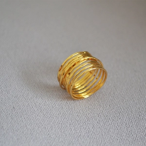 Detailed macro view of gold multi-layered wire-wrapped ring with hammered texture