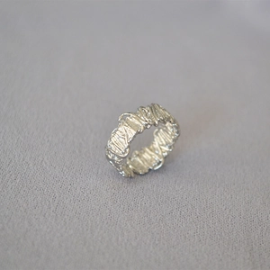Detailed view of silver wire-wrapped open ring with artistic textured finish for women