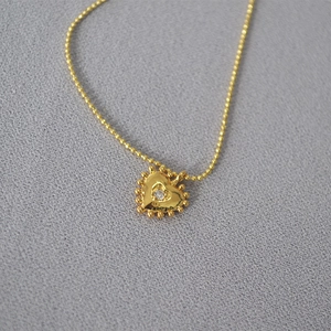 Vintage gold heart pendant necklace with center crystal and beaded edge details