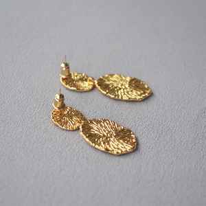 Artistic gold drop earrings with unique organic texture and irregular geometric shapes