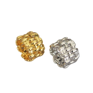 Irregular woven gold and silver wide band brass rings set on a white background