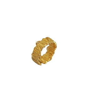 Textured gold open ring featuring a unique irregular hammered surface and minimalist style