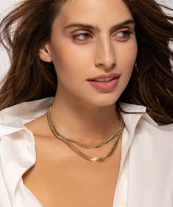 Nahaufnahme von geschichteten goldenen Schlangenkette-Halsketten an einem Model