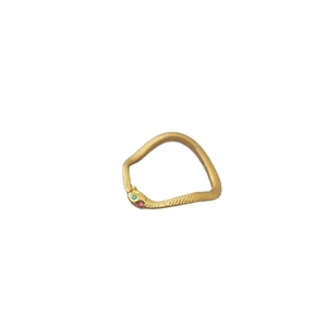 Elegant gold snake-shaped open ring with intricate scales and green gemstone eyes