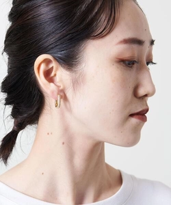 Close-up of gold U-shaped hoop earrings with pave cubic zirconia on a model ear