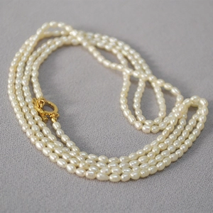 Détail d'un collier de perles d'eau douce multi-rangs avec fermoir OT doré