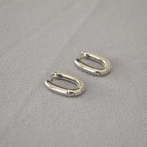 U-shaped hoop earrings with silver-toned metal and half-pave zirconia stones
