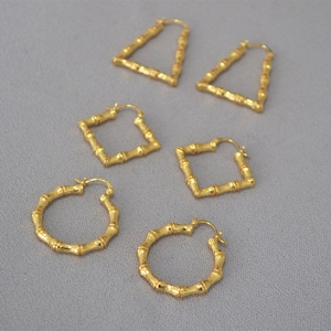 Close-up of gold-plated bamboo texture on square, round and triangle earrings