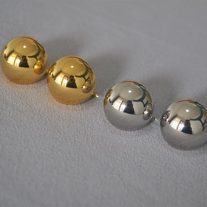 Polished gold and silver hollow sphere earrings in high-gloss brass mirror finish