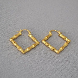 Retro gold-plated brass hoop earrings featuring a geometric bamboo texture design