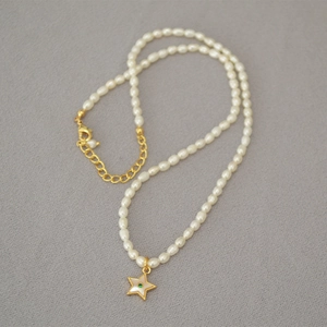 Freshwater rice pearl necklace with a gold star pendant and green zircon accent