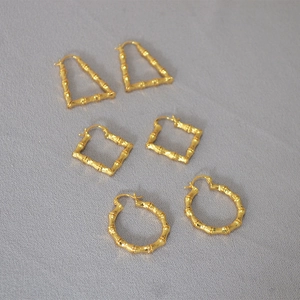 Detailed set of three gold bamboo-textured earrings in round, triangle, and square shapes