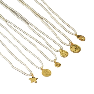 Minimalist freshwater pearl necklaces with various vintage gold coin and star pendants