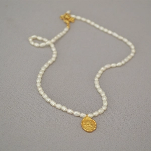 French vintage freshwater pearl necklace with a gold queen portrait coin pendant