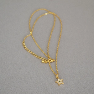 Detail view of star pendant necklace with green stone and gold adjustable clasp chain