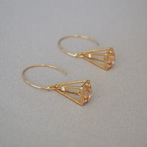 Gold-plated pyramid cage drop earrings with champagne cubic zirconia in a minimalist style