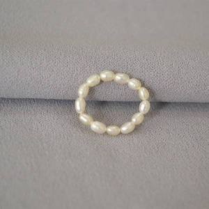Detailed view of natural freshwater rice pearls on an elegant elastic string ring