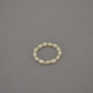 Macro shot of minimalist freshwater rice pearl beaded elastic ring for women