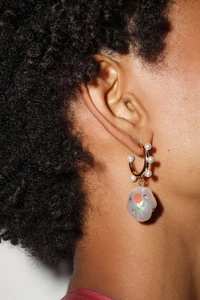 Close-up of Baroque pearl earrings with red rose pendant in vintage gold finish