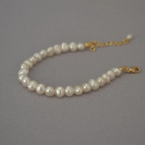 Close-up of elegant freshwater pearl bracelet with gold-plated lobster clasp and extender