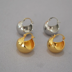 Polished hollow spherical brass earrings in gold and silver with textured inner walls
