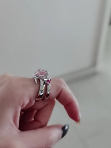 Dettaglio di doppi anelli in argento con pietra rosa a goccia e piccola gemma rossa finissima
