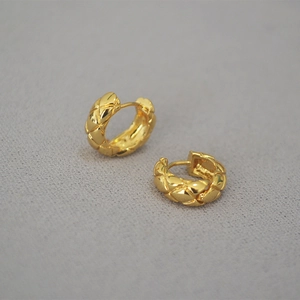 Detailed view of quilted pattern texture on gold plated brass hoop earrings